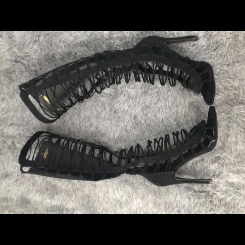 Black strappy knee high heels.